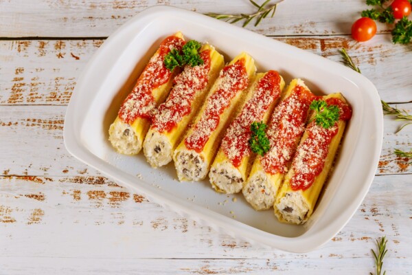 Cannelloni pasta stuffed with ricotta, mushrooms and tomato sauce.