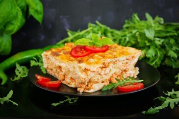 Classic Lasagna with bolognese sauce on dark background