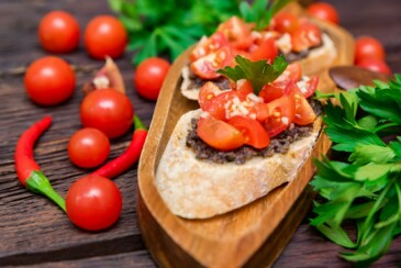 Fresh tasty bruschetta with truffle sauce, parsley and tomates