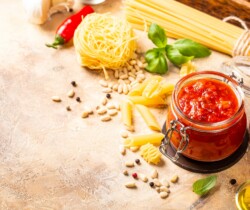 Glass jar with homemade classic spicy tomato pasta or pizza sauce.