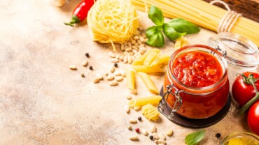 Glass jar with homemade classic spicy tomato pasta or pizza sauce.